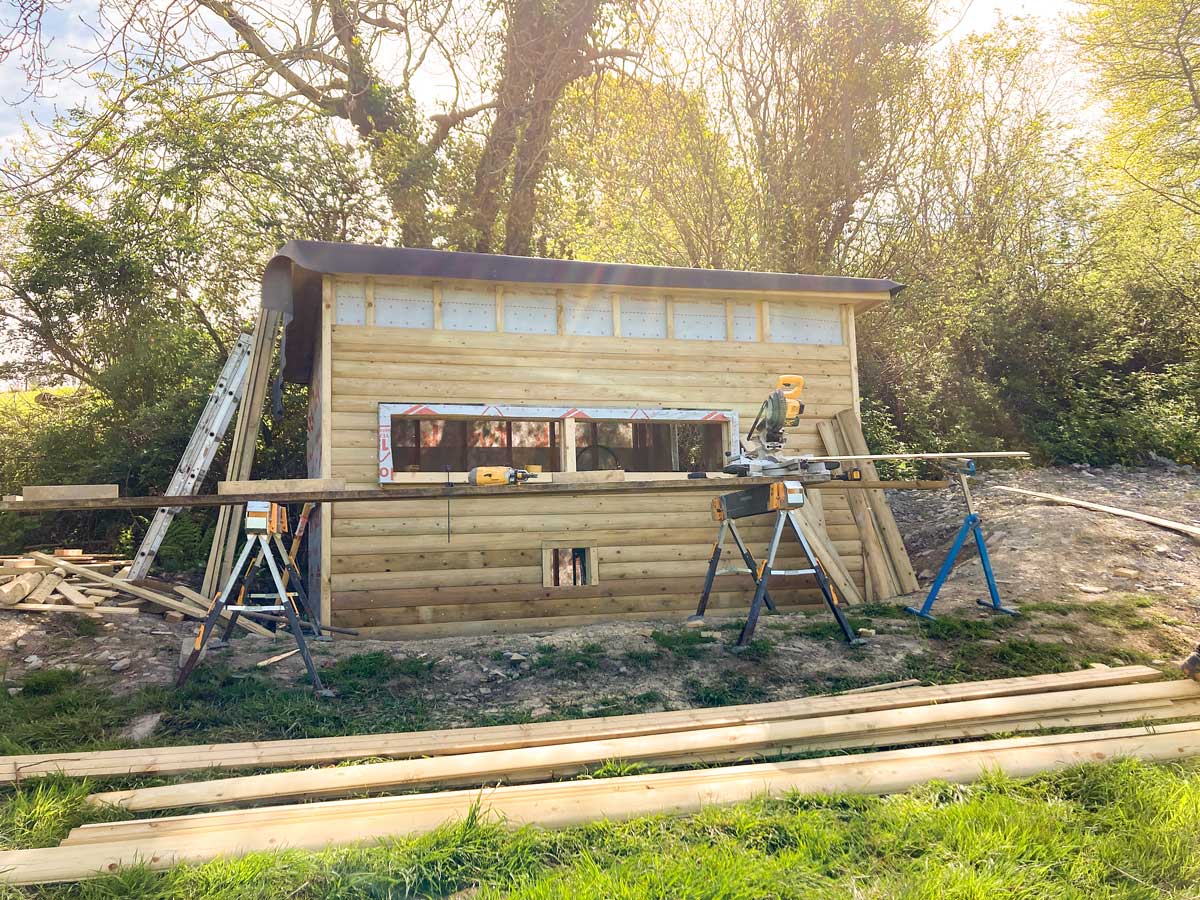 Buildings a bird hide by hand